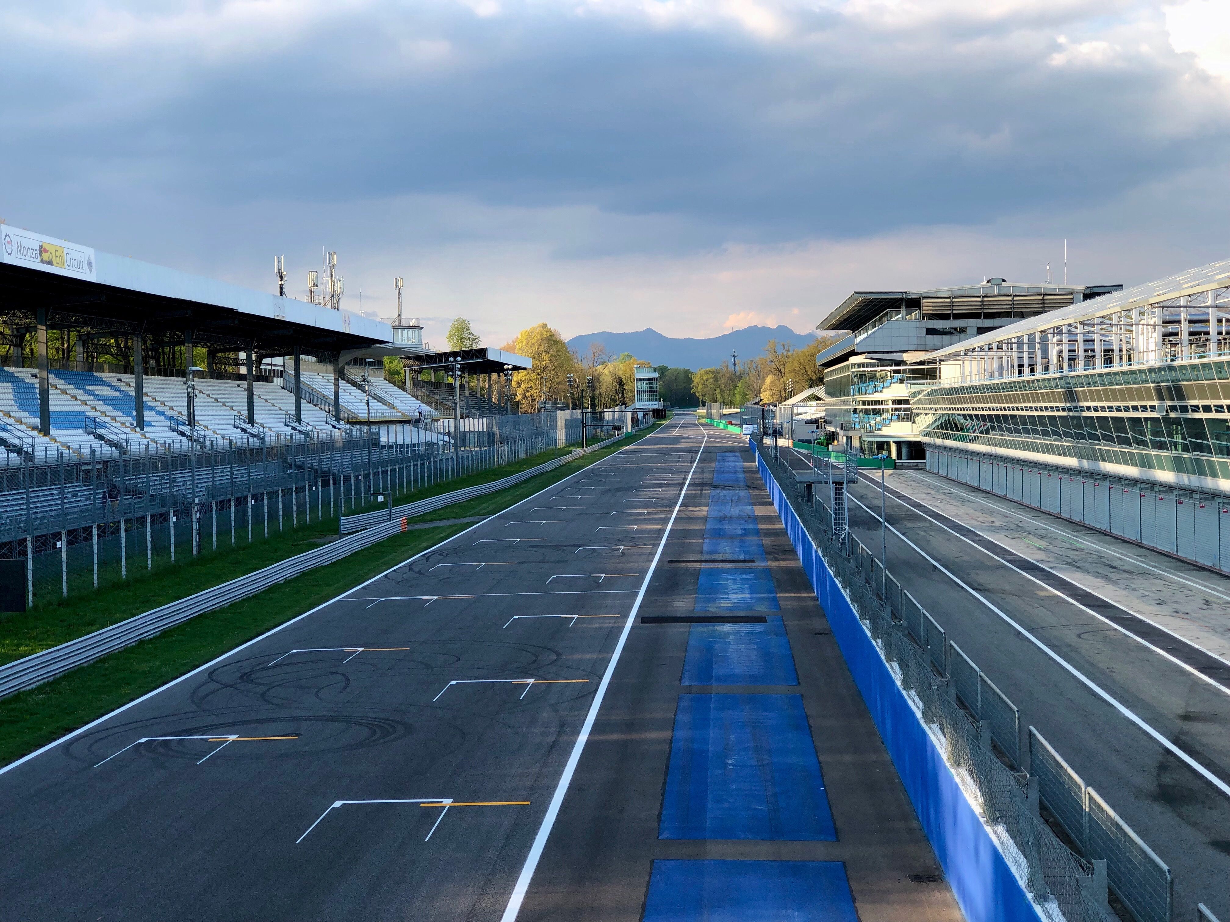 The empty pit straight at Monza Circuit under a cloudy sky