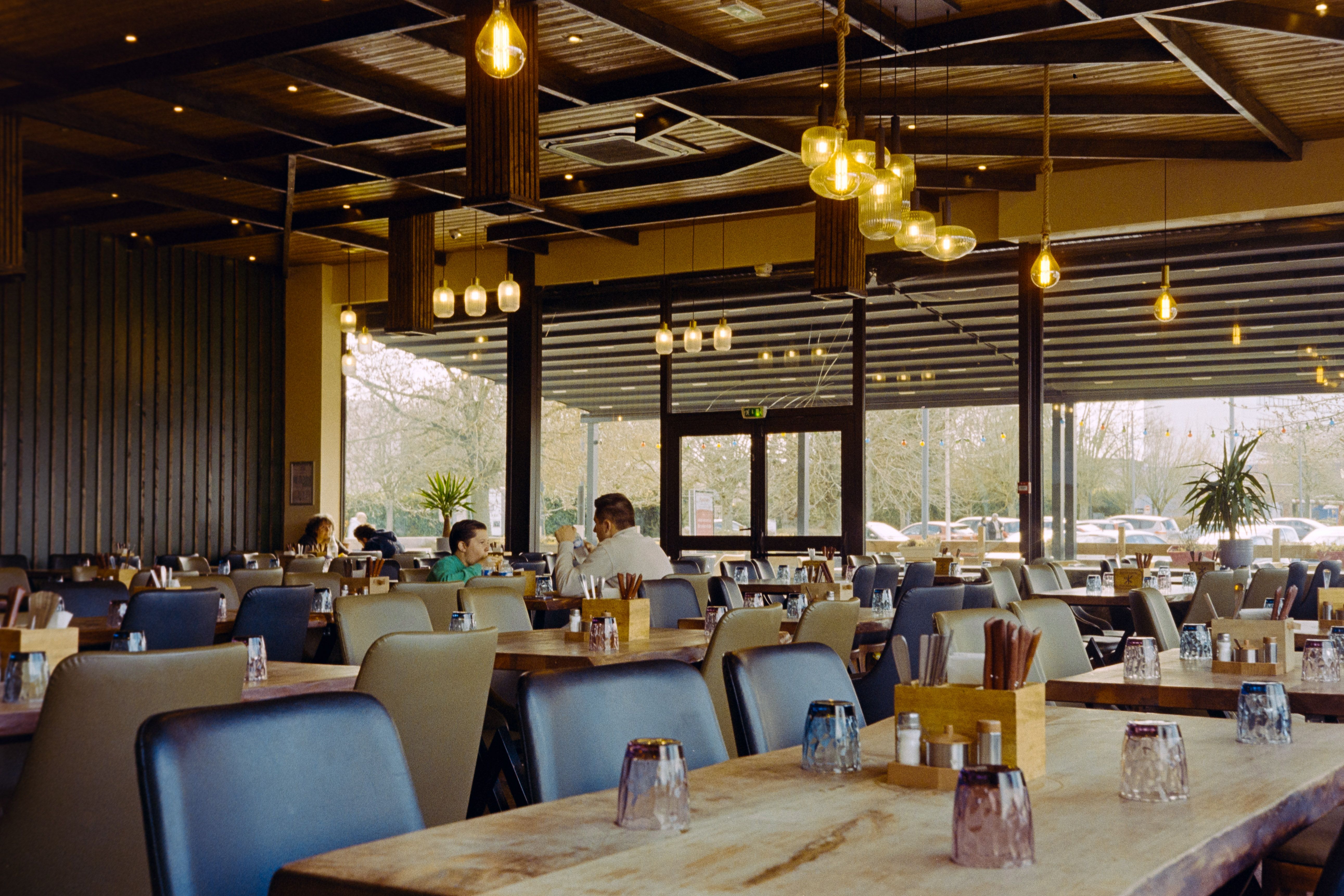 Warm, candlelit French bistro interior with diners at tables — evocative of Bistrot Vérité's intimate neighbourhood atmosphere