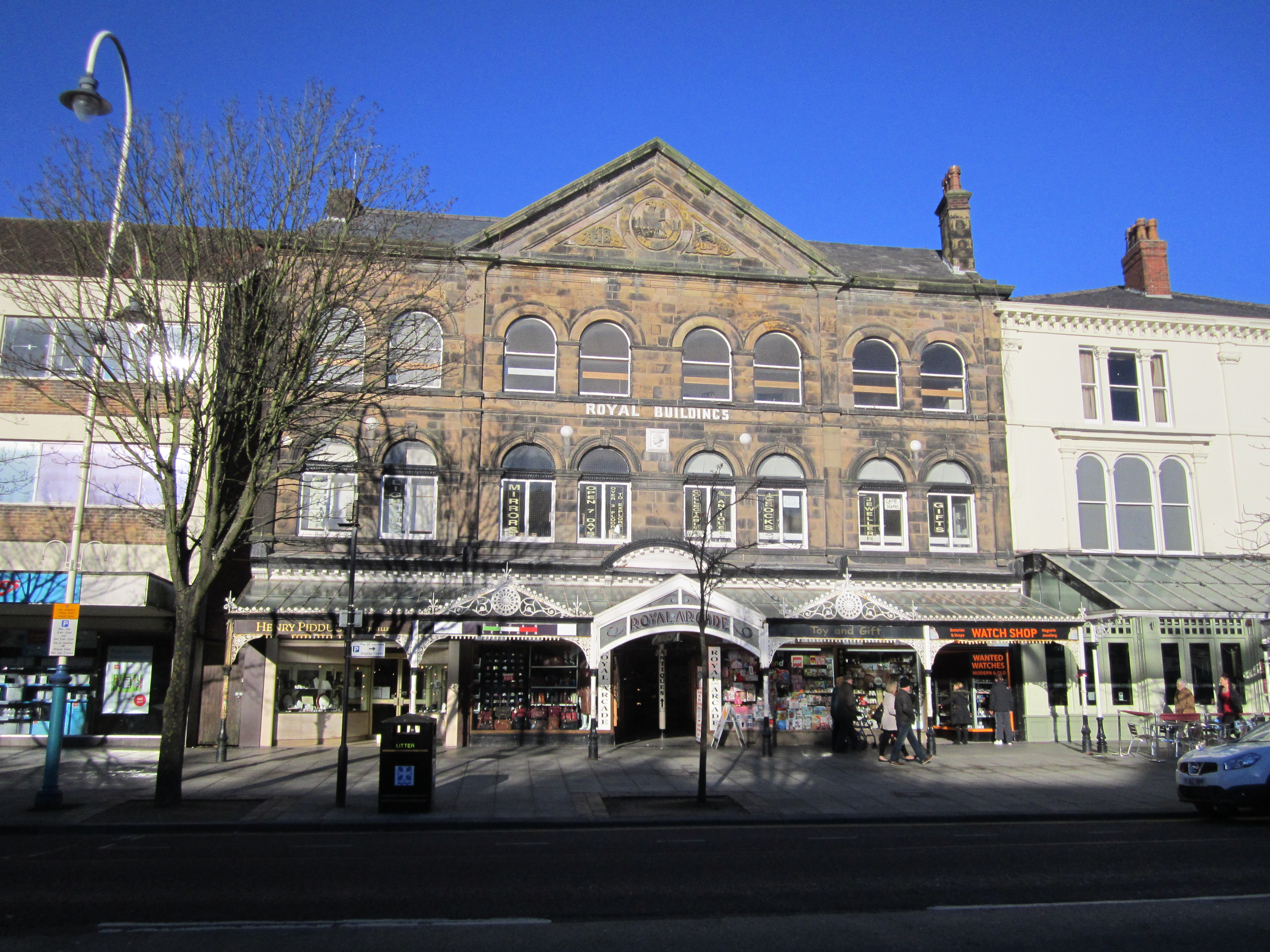 The glass-and-iron canopy of Royal Arcade on Lord Street, Southport — the signature architectural detail of the Victorian boulevard