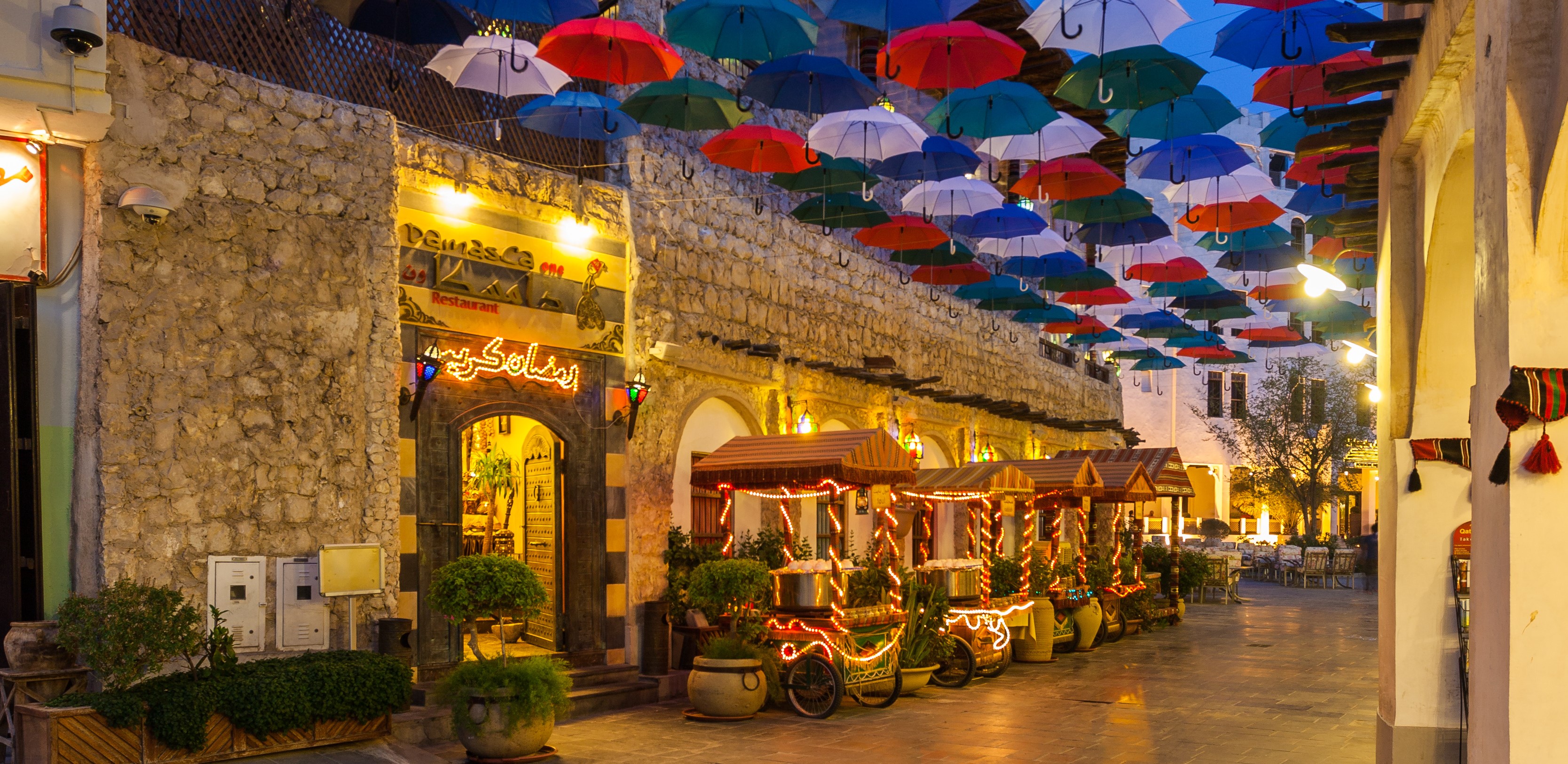 Vibrant alley with colourful umbrella canopy, Souq Waqif, Doha