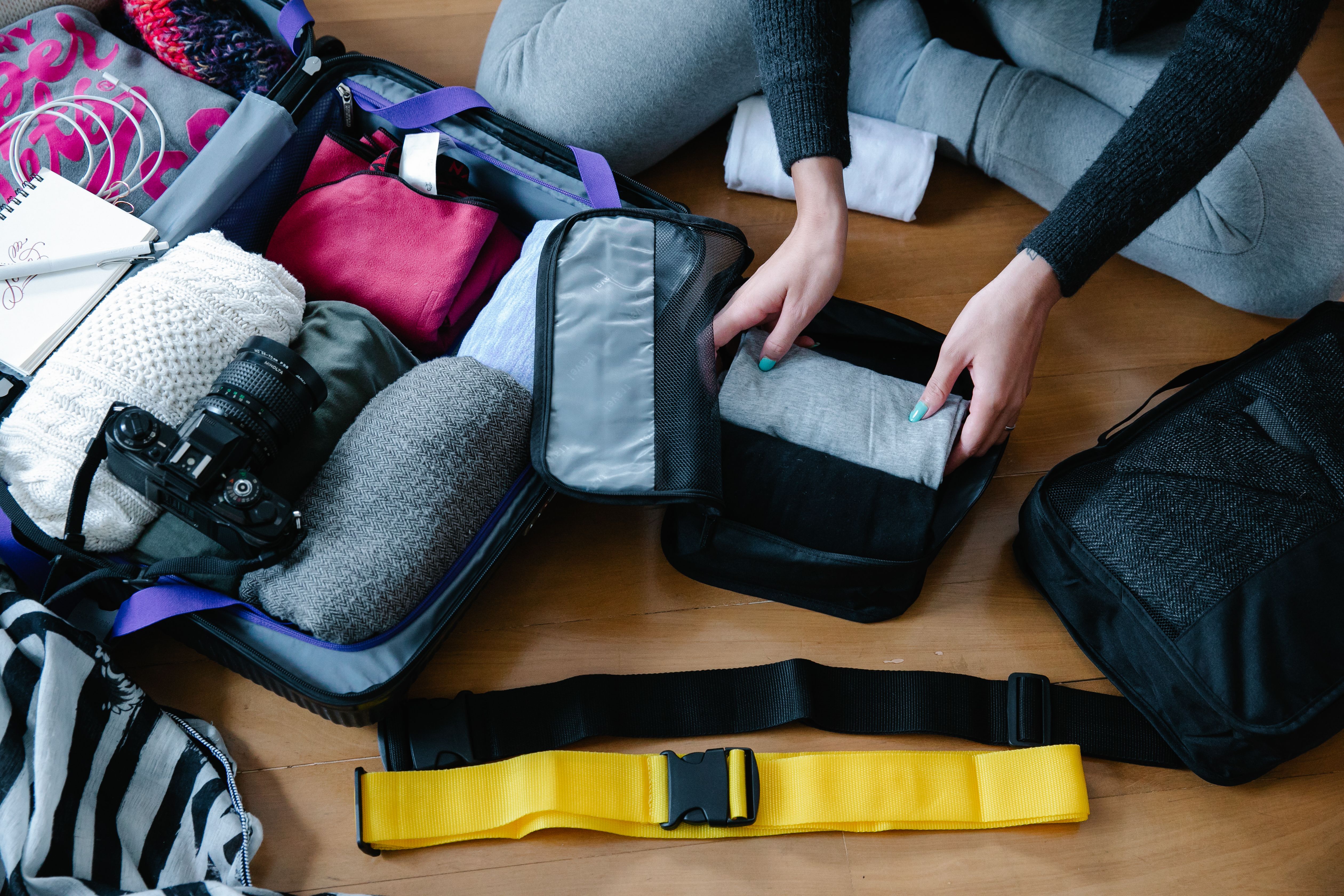 Packed suitcase and travel essentials for a race weekend trip
